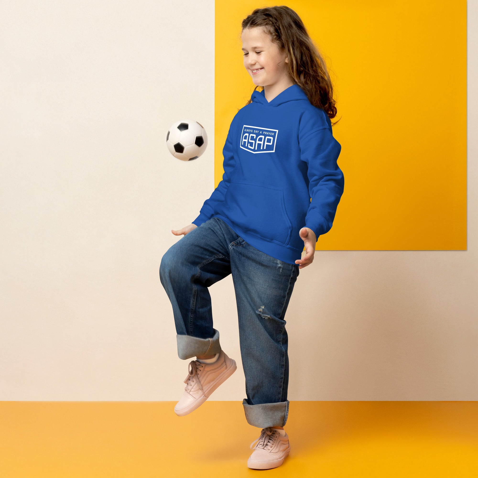 young girl playing football wearing a heavy blend hoodie blue with white asap print